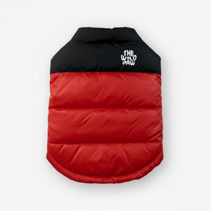Red and black puffer dog coat with 'The Wild Paw' logo on a white background
